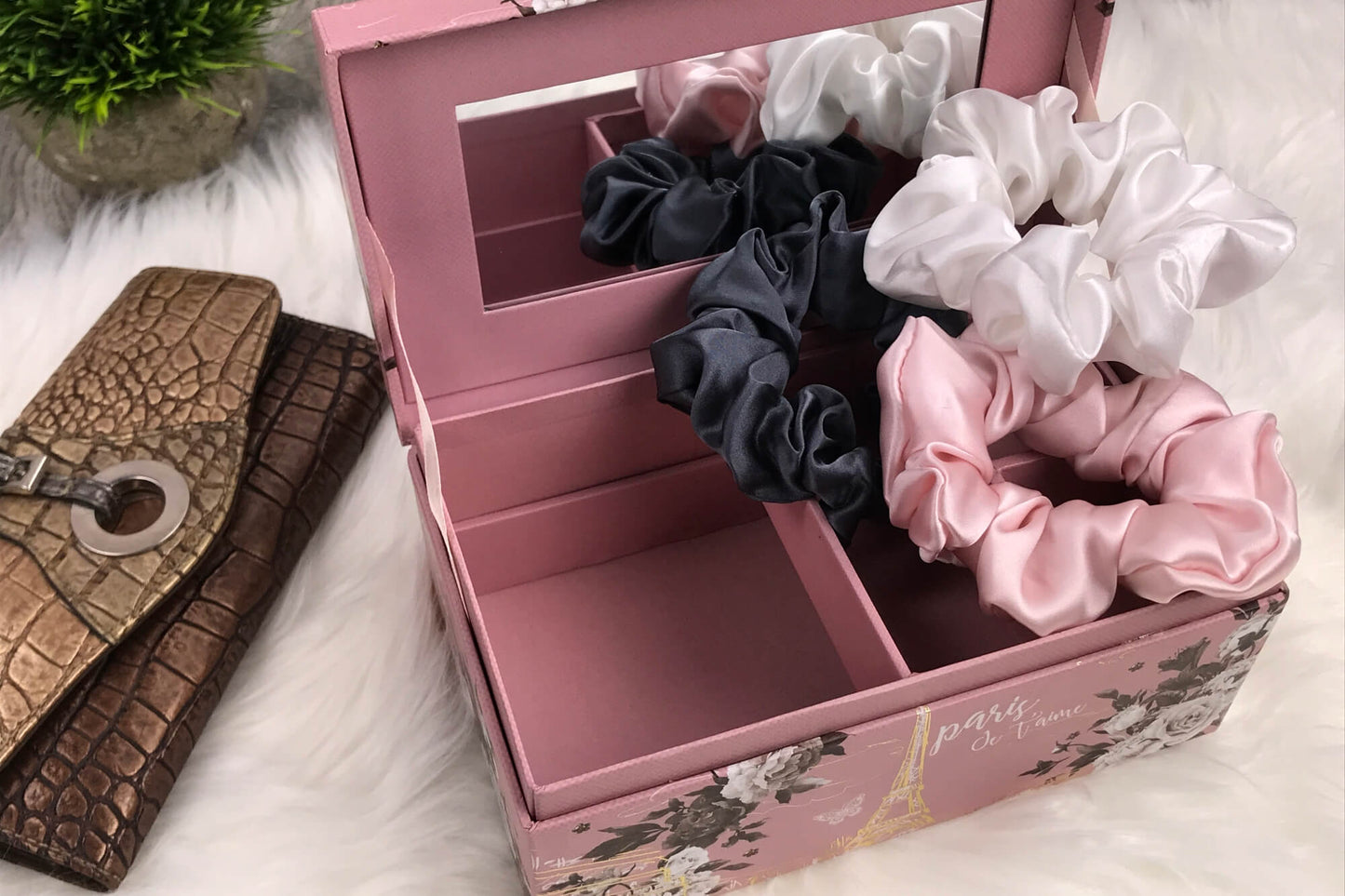 Celestial Silk large charcoal ivory and pink silk scrunchies stacked on marble counter with plant and wallet in the background