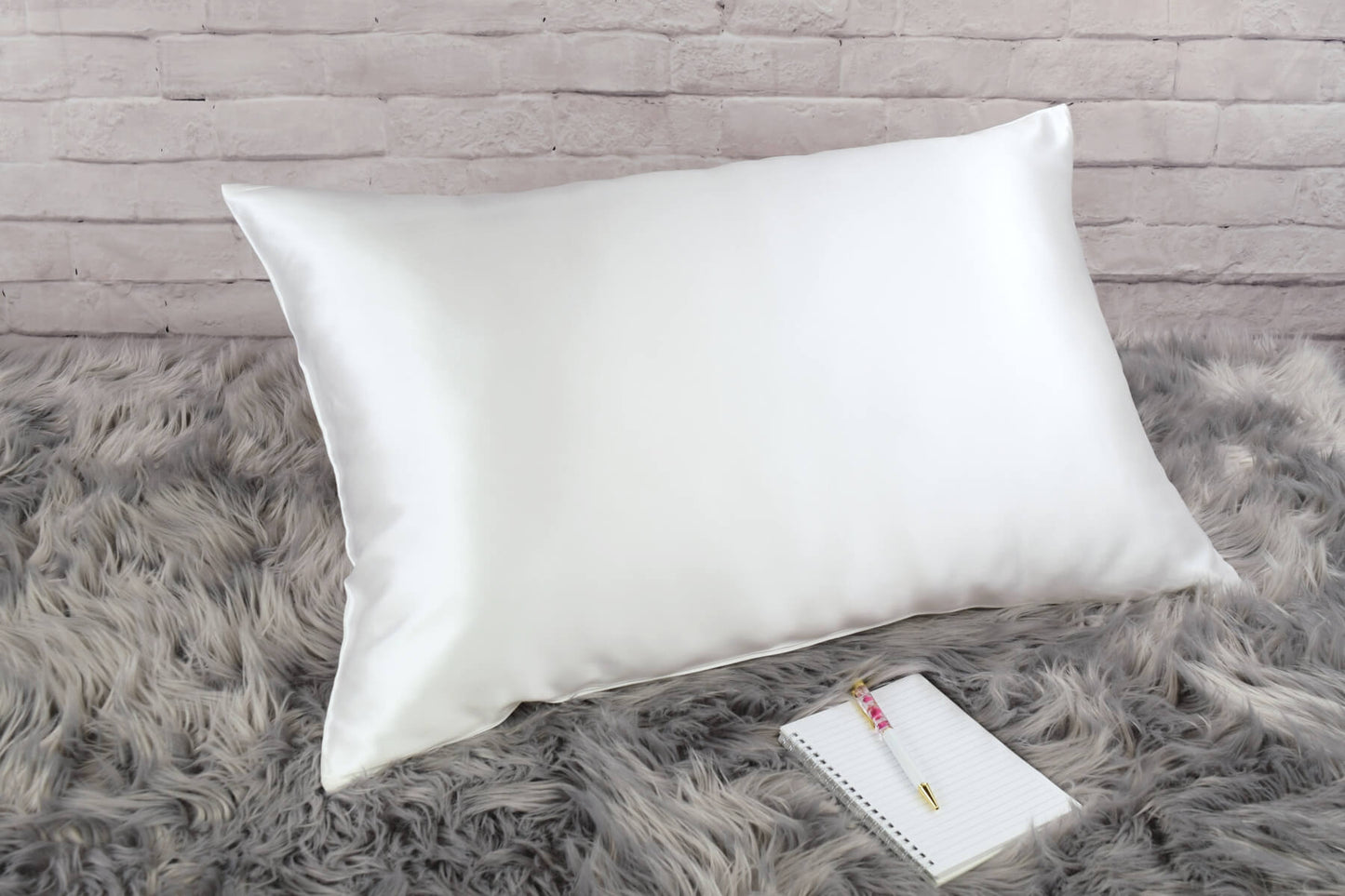 Celestial Silk Undyed ivory 25 momme Silk Pillowcase on rug with notebook and pretty pen