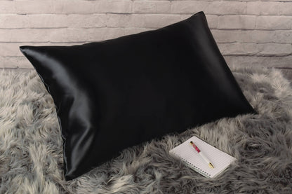 Celestial Silk 25 momme black silk pillowcase on faux fur rug with notebook and pretty pen