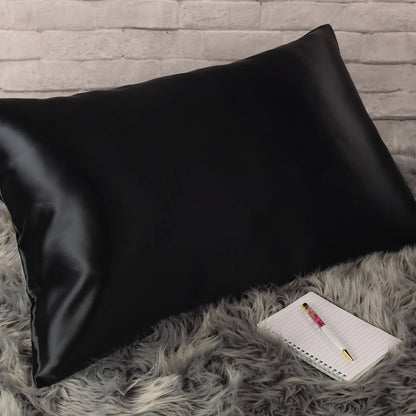 Celestial Silk Black 25 momme Silk Pillowcase on rug with notebook and pretty pen