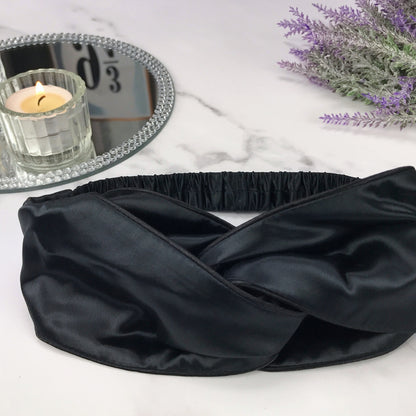 celestial silk twisted black silk headband for hair on counter with lavender and candle