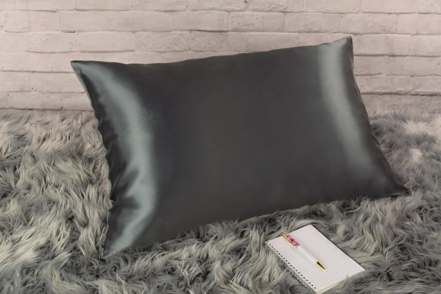 Celestial Silk 25 momme charcoal gray silk pillowcase on faux fur rug with notebook and pretty pen