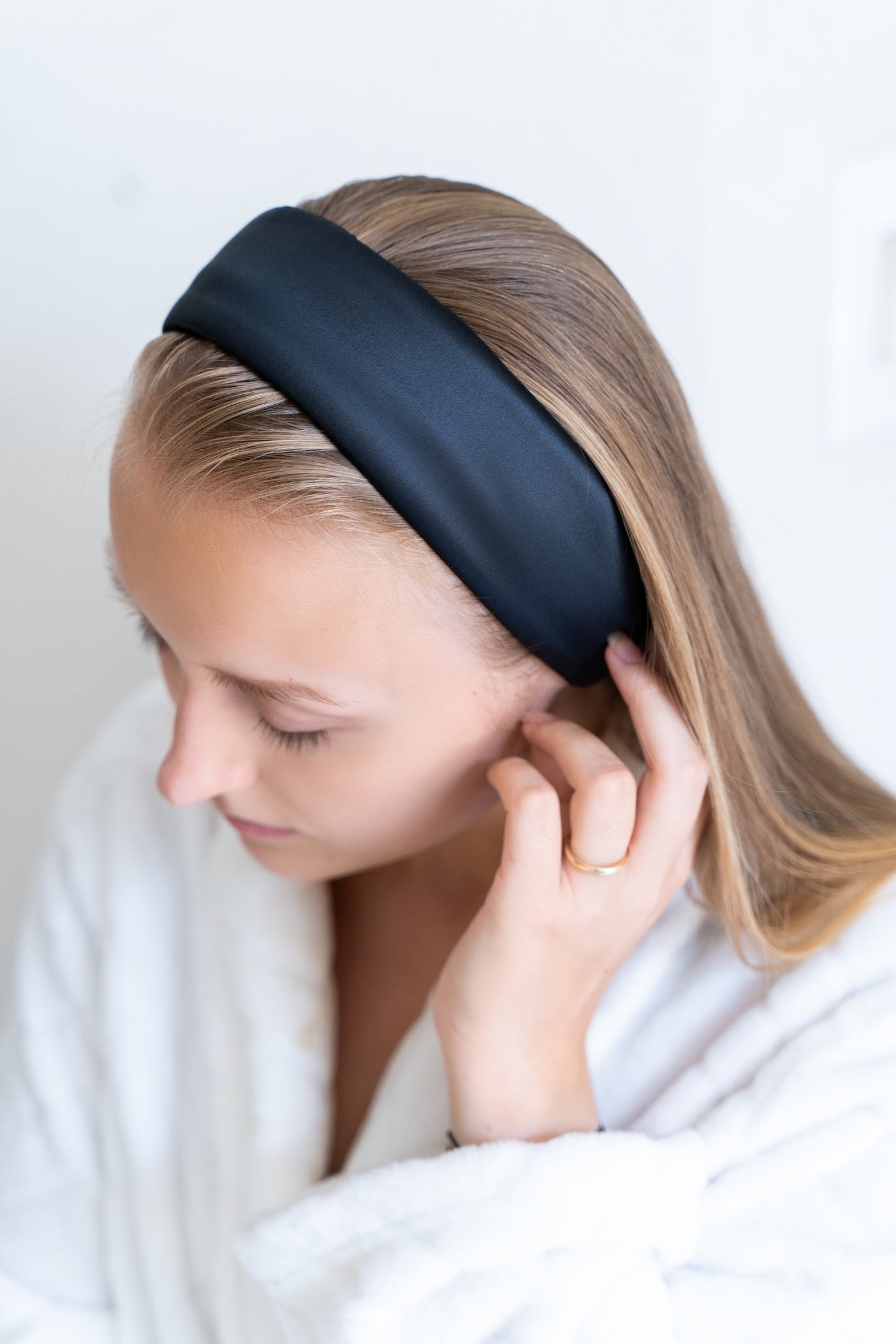 silk spa headband with velcro attachment on woman with blond hair in soft terry cloth robe