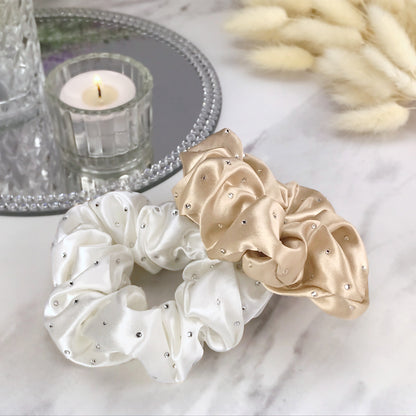 Celestial Silk scrunchies with crystals, silk hair ties with rhinestones taupe and ivory silk hair scrunchies on marble vanity with candle and mirror tray
