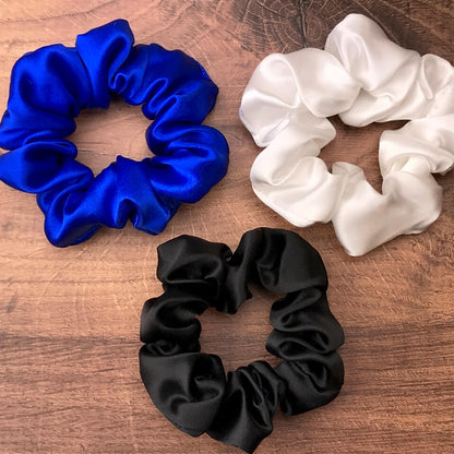 blue white black silk scrunchies mulberry silk scrunchies for hair laying on wood vanity