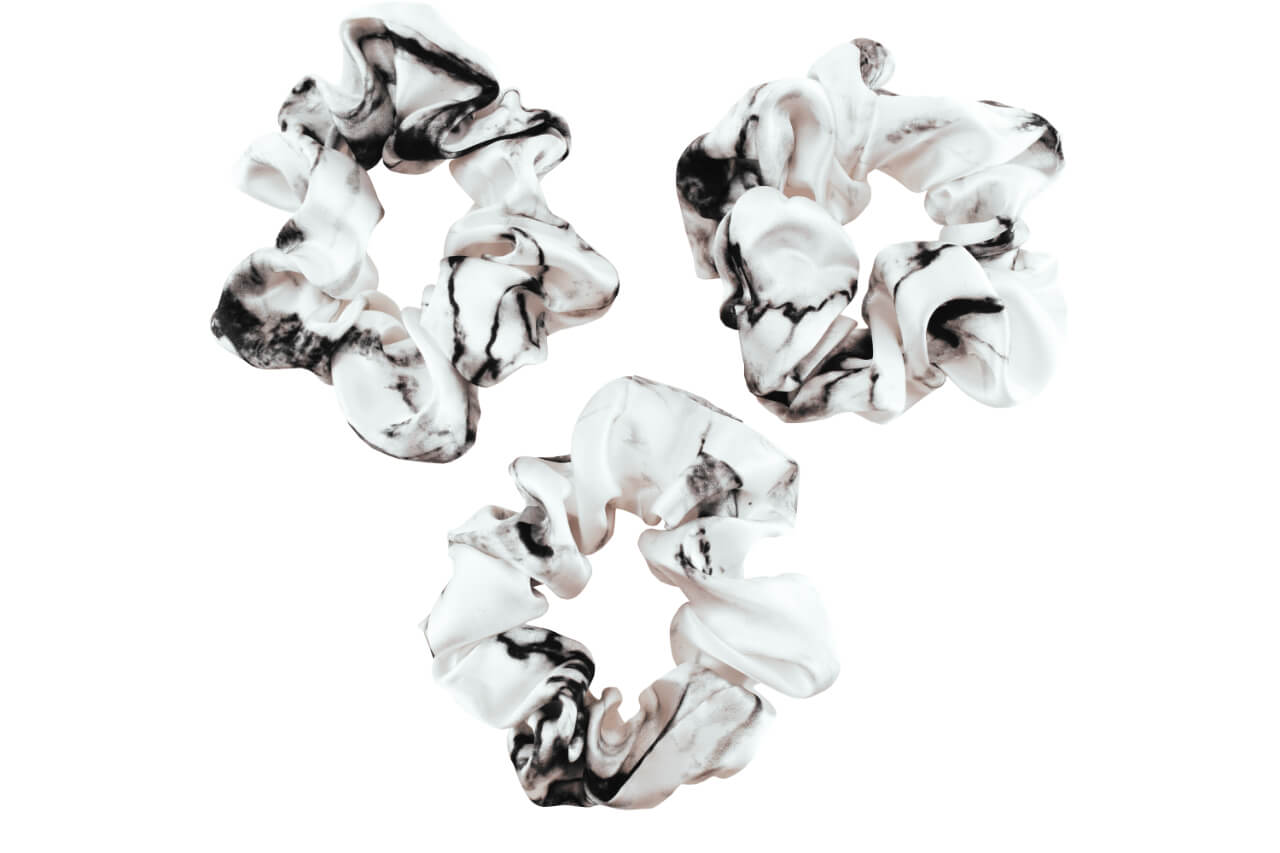 White marble silk scrunchies by celestial silk with a white background