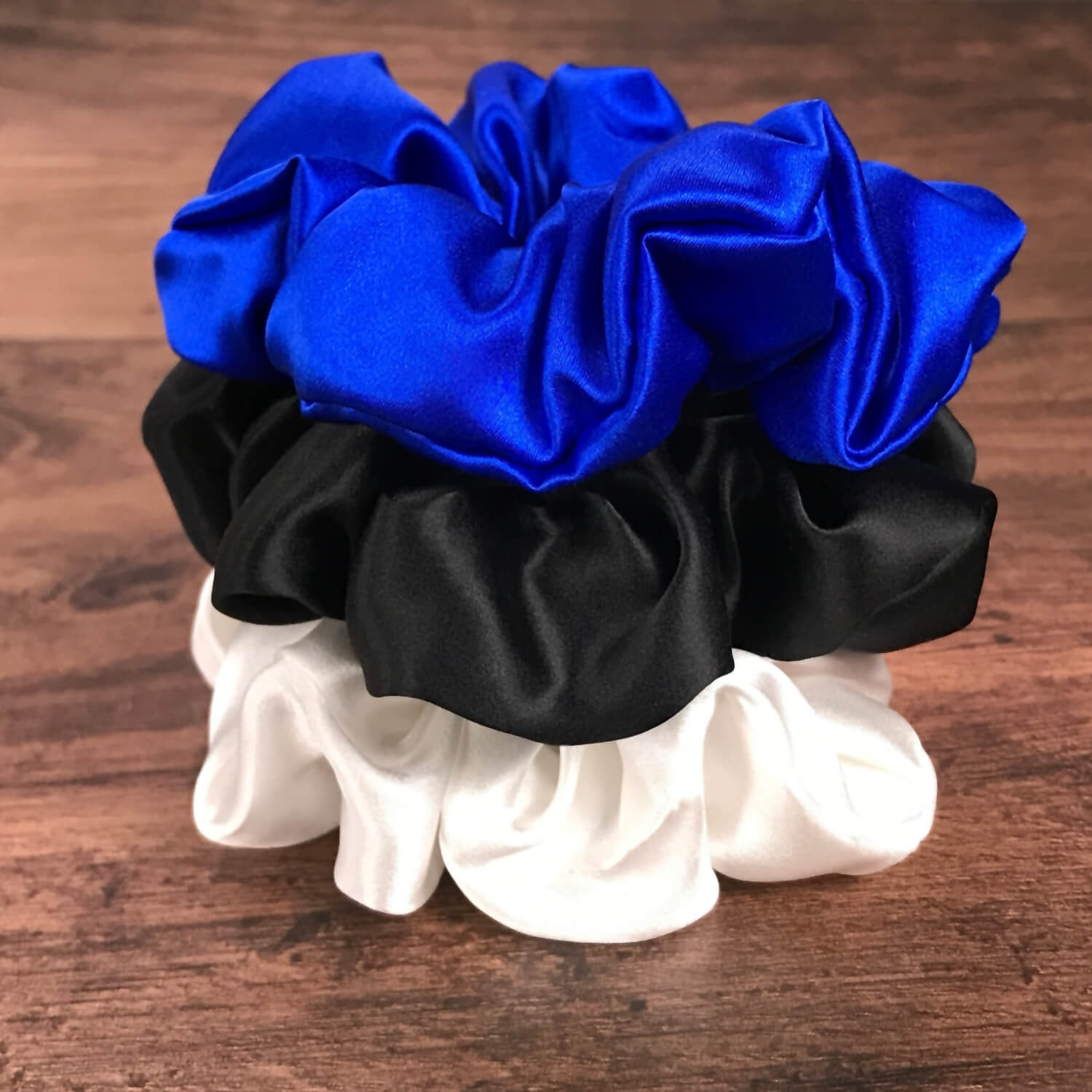 blue white black silk scrunchies mulberry silk scrunchies for hair stacked on wood vanity