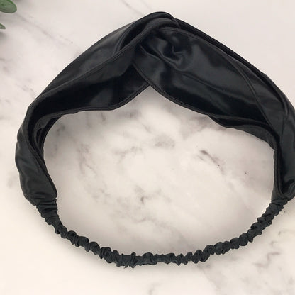 celestial silk twisted black silk headband for hair on counter with aloe