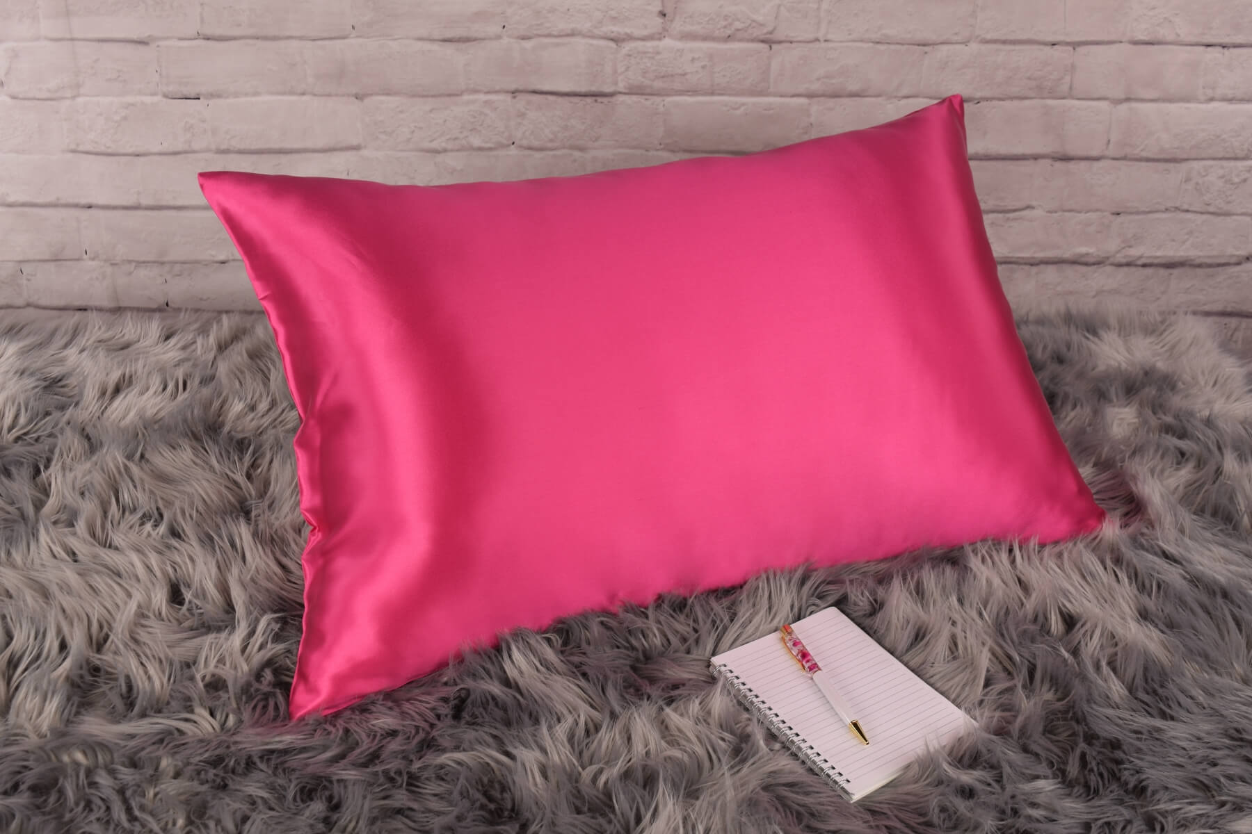 Celestial Silk Hot pink 25 momme Silk Pillowcase on rug with notebook and pretty pen