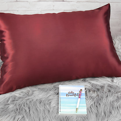 Celestial Silk Maroon 25 momme Silk Pillowcase on rug with notebook and pretty pen
