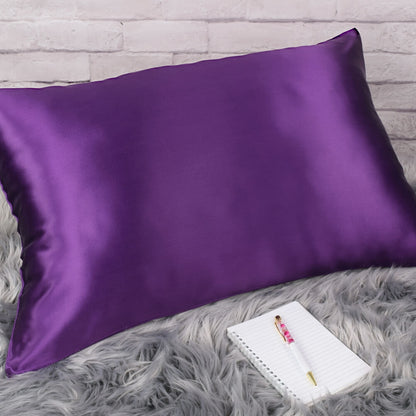Celestial Silk Plum 25 momme Silk Pillowcase on rug with notebook and pretty pen