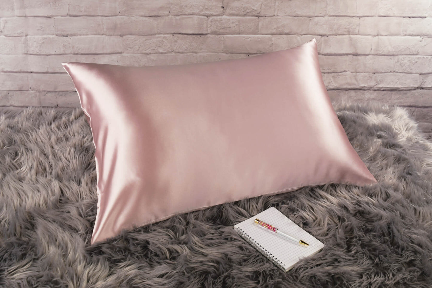 Celestial Silk Vintage pink 25 momme Silk Pillowcase on rug with notebook and pretty pen
