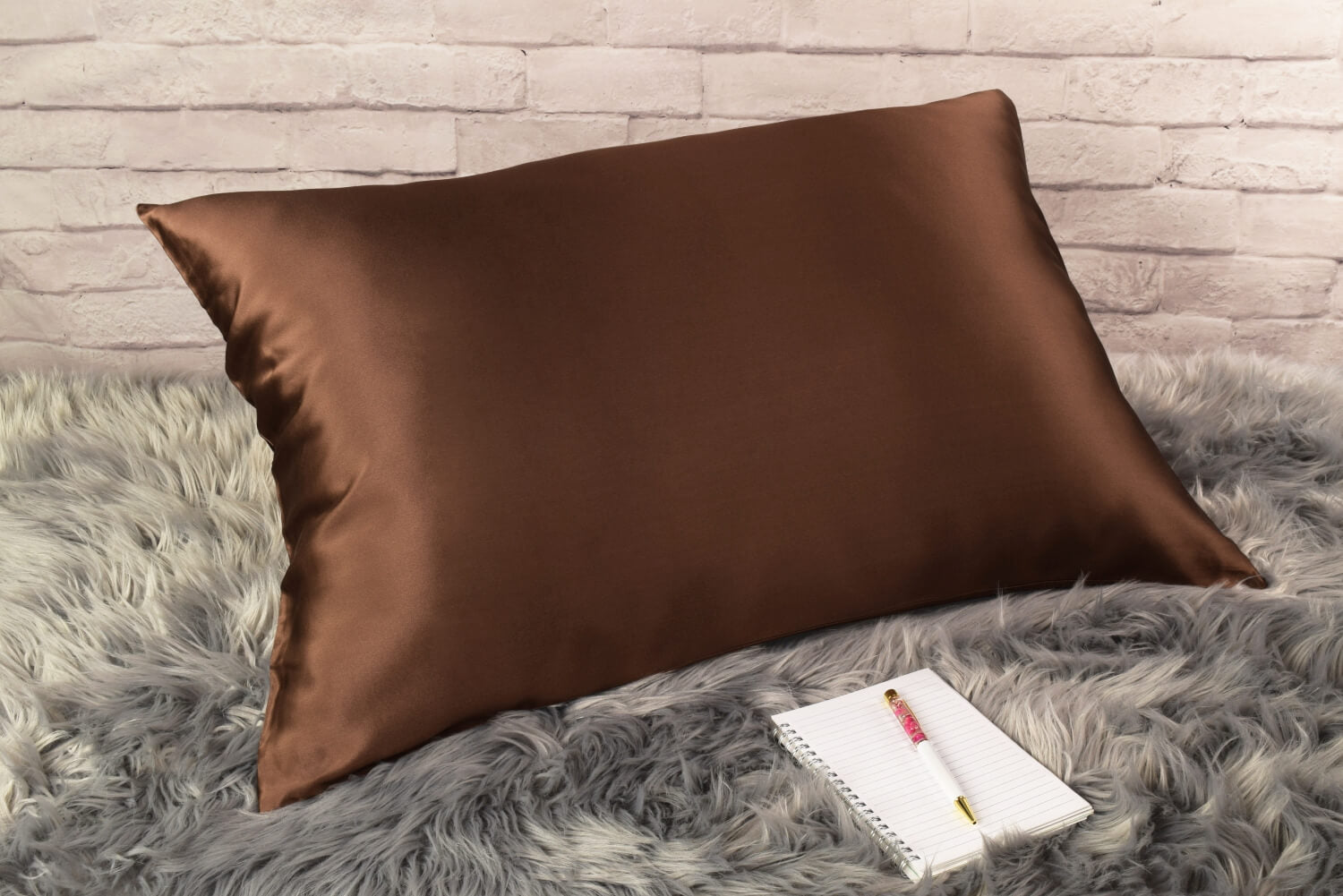 Celestial Silk 25 momme chocolate silk pillowcase on faux fur rug with notebook and pretty pen