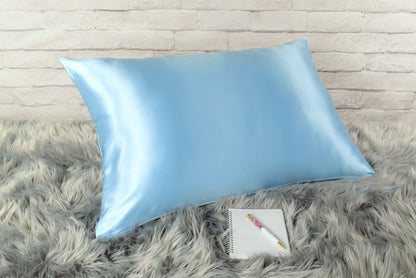 Celestial Silk 25 momme icy blue silk pillowcase on faux fur rug with notebook and pretty pen