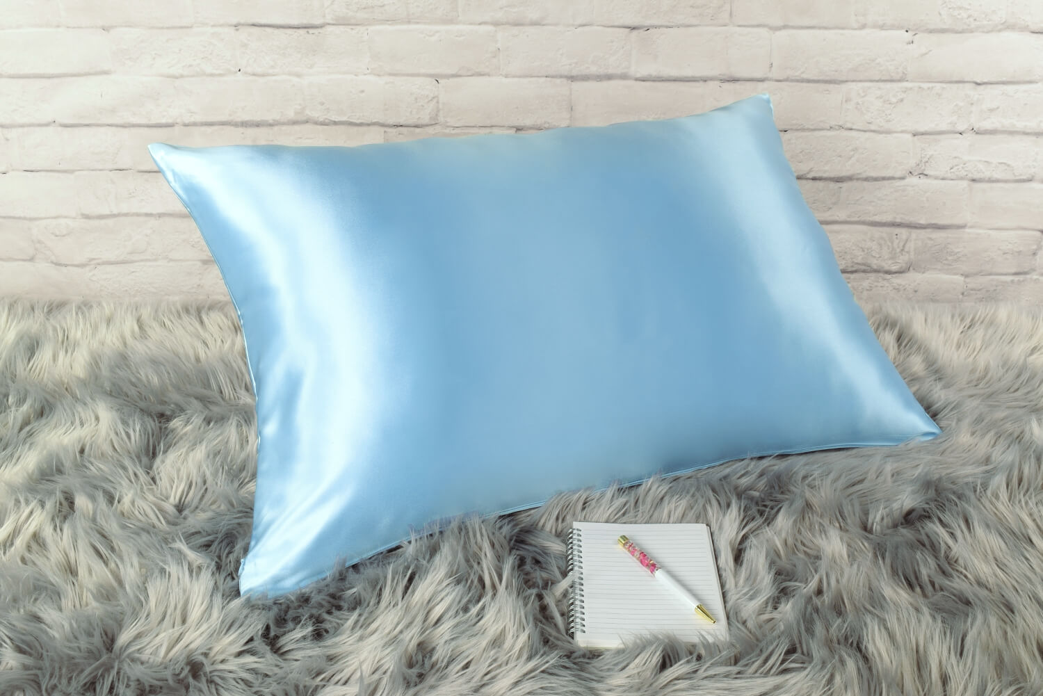 Celestial Silk Icy blue 25 momme Silk Pillowcase on rug with notebook and pretty pen