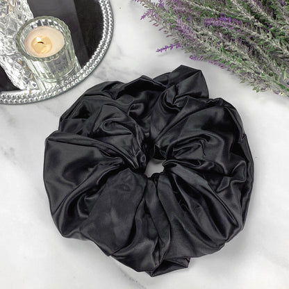 celestial silk oversized silk scrunchie on marble counter with candle and mirror tray
