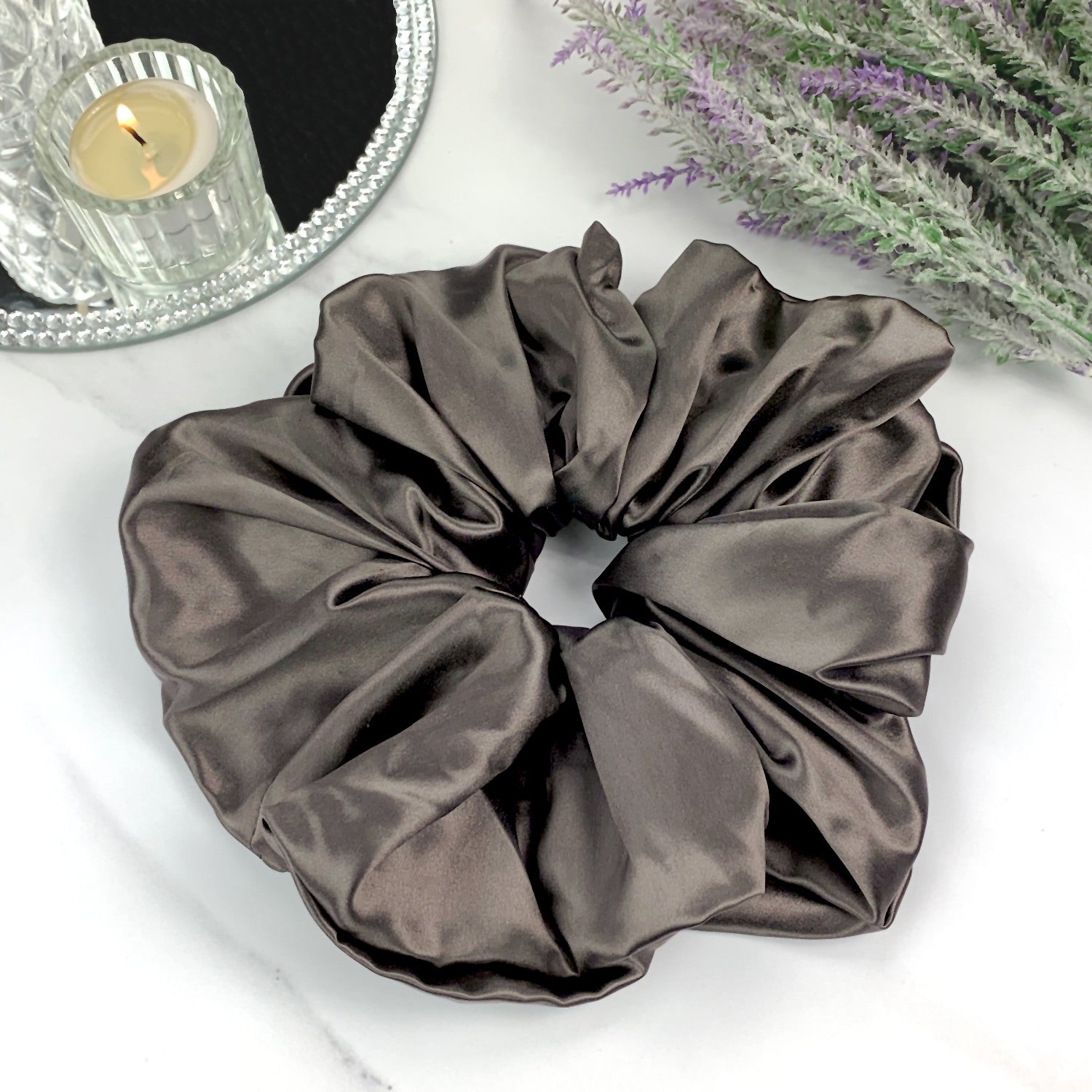 oversized silk scrunchie charcoal gray on marble counter with candle