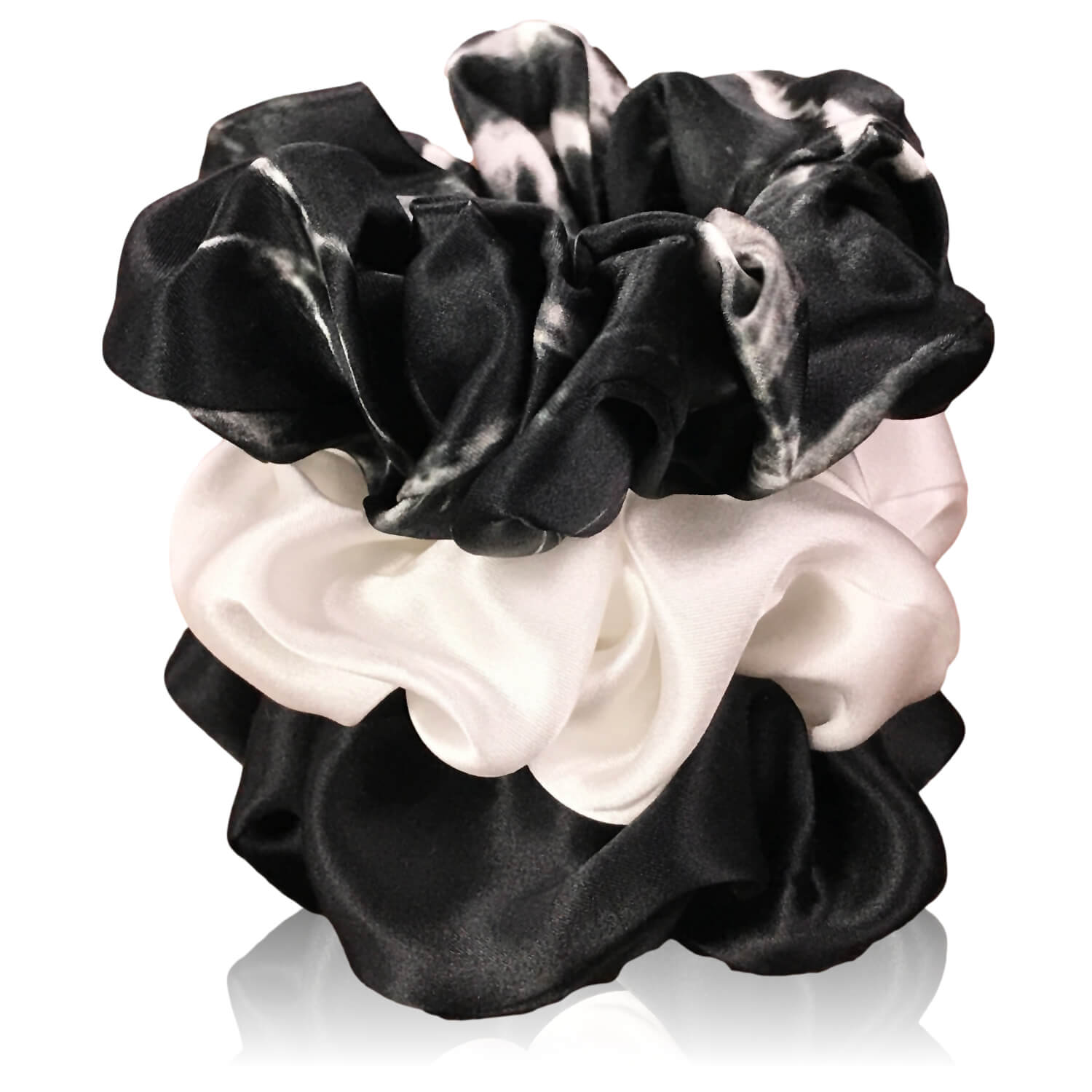 Black marble, ivory and black silk scrunchies by celestial silk stacked with a white background