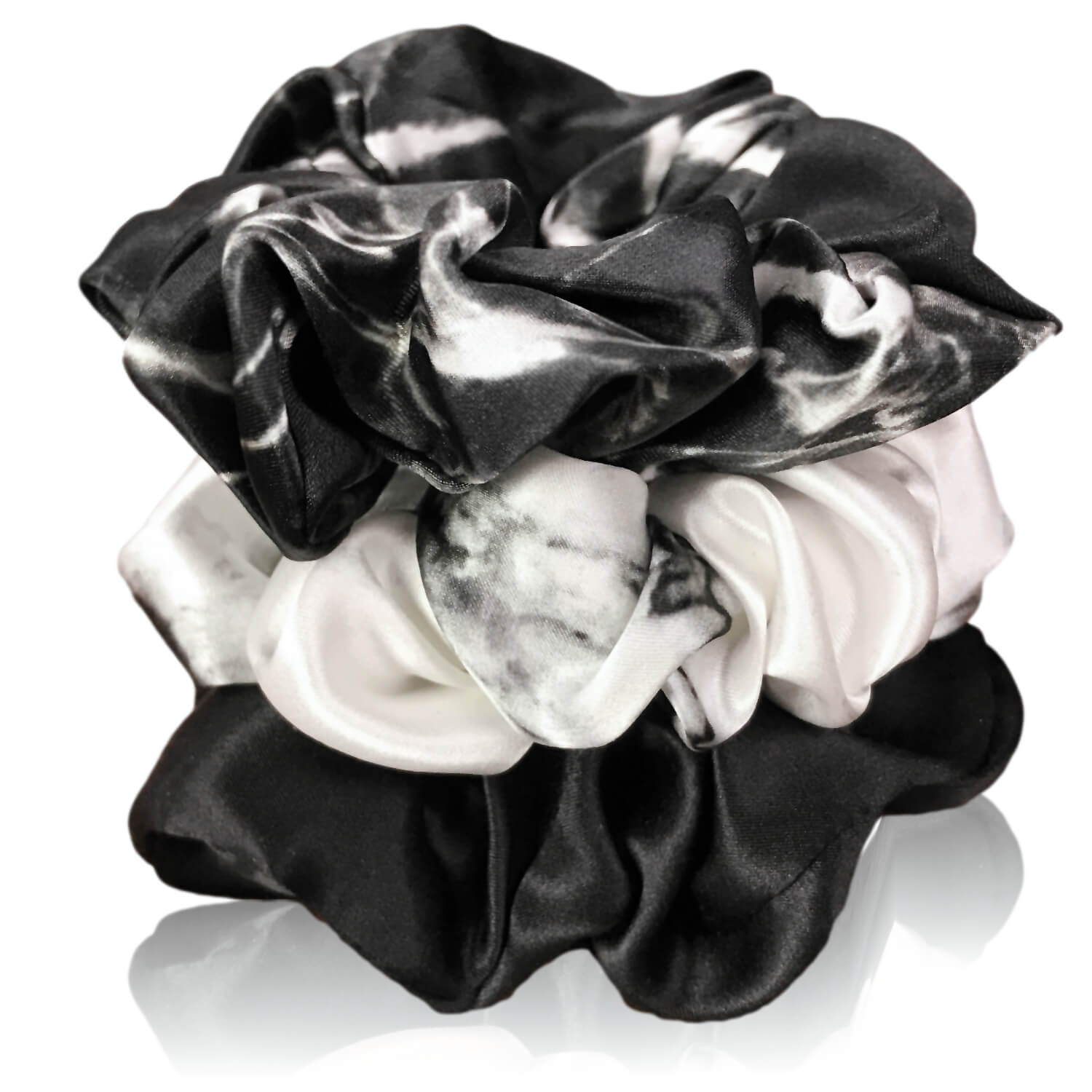 marble silk scrunchies by celestial silk stacked with a white background