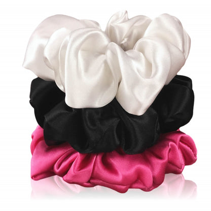 Black hot pink and white silk scrunchies by celestial silk stacked with a white background