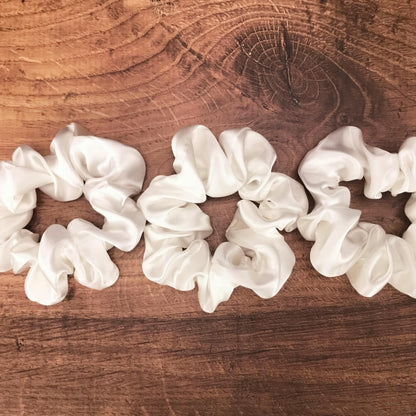  Large undyed ivory silk hair ties by Celestial Silk stacked side by side on a wood vanity