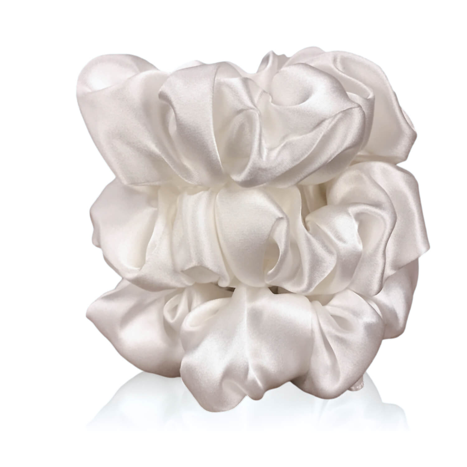 Undyed ivory silk scrunchies by celestial silk stacked with a white background