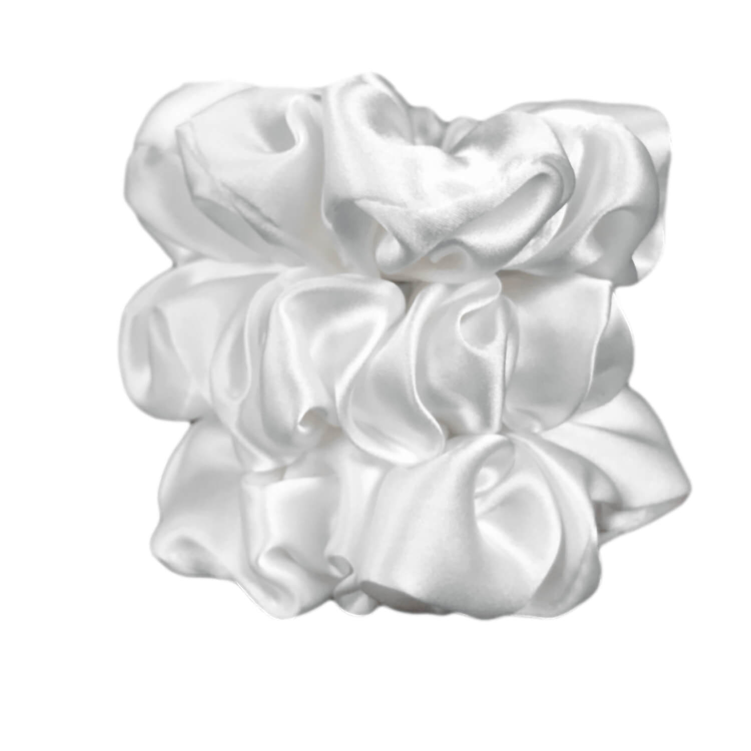 White silk scrunchies by celestial silk stacked with a white background