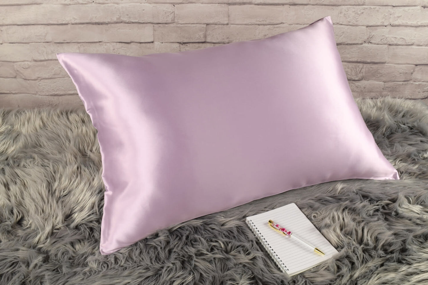 Celestial Silk 25 momme lavender silk pillowcase on faux fur rug with notebook and pretty pen