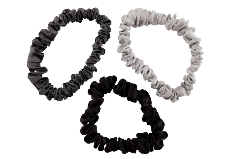 Charcoal black and silver silk scrunchies by celestial silk stacked with a white background