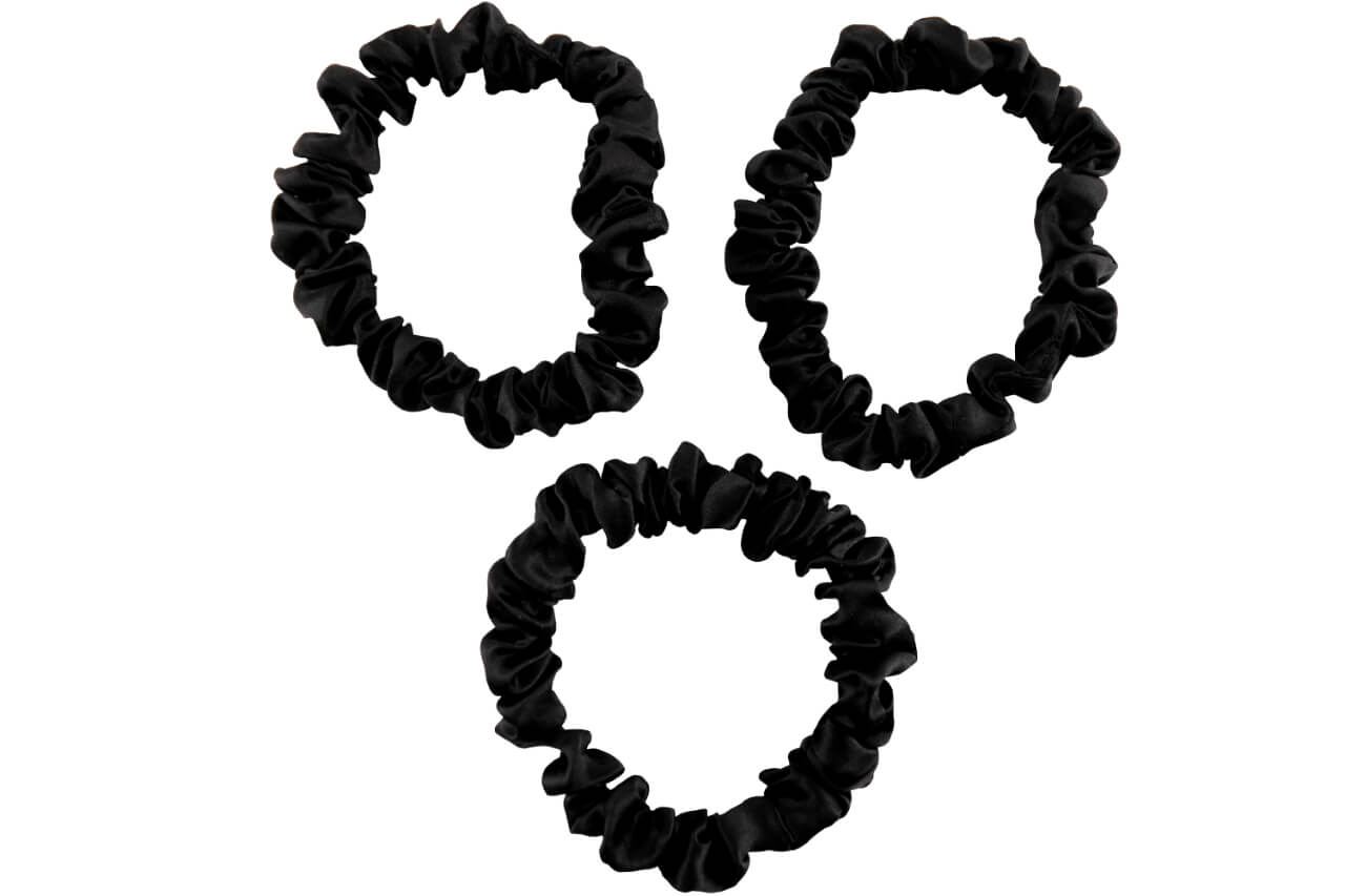 Black silk scrunchies by celestial silk stacked with a white background