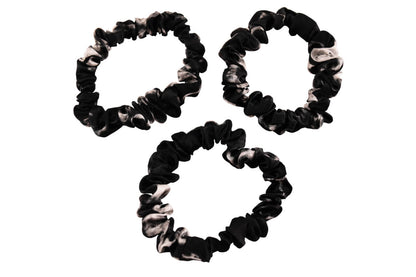 Black marble scrunchies by celestial silk stacked with a white background