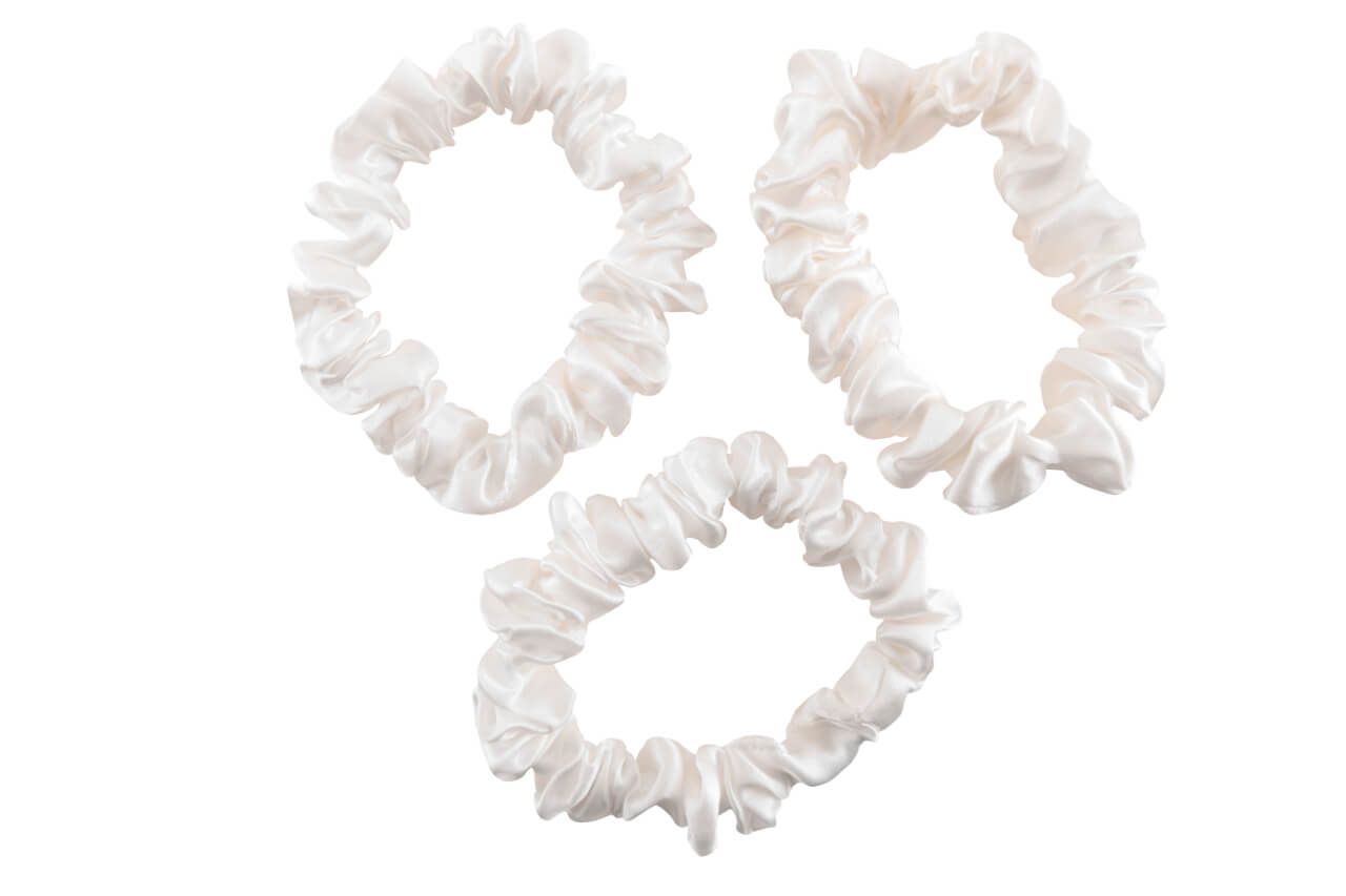 Ivory silk scrunchies by celestial silk stacked with a white background