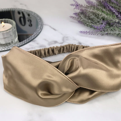 celestial silk twisted taupe silk headband for hair  on counter with lavender and mirror tray