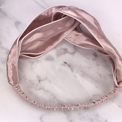 celestial silk twisted vintage pink silk headband for hair on counter with aloe
