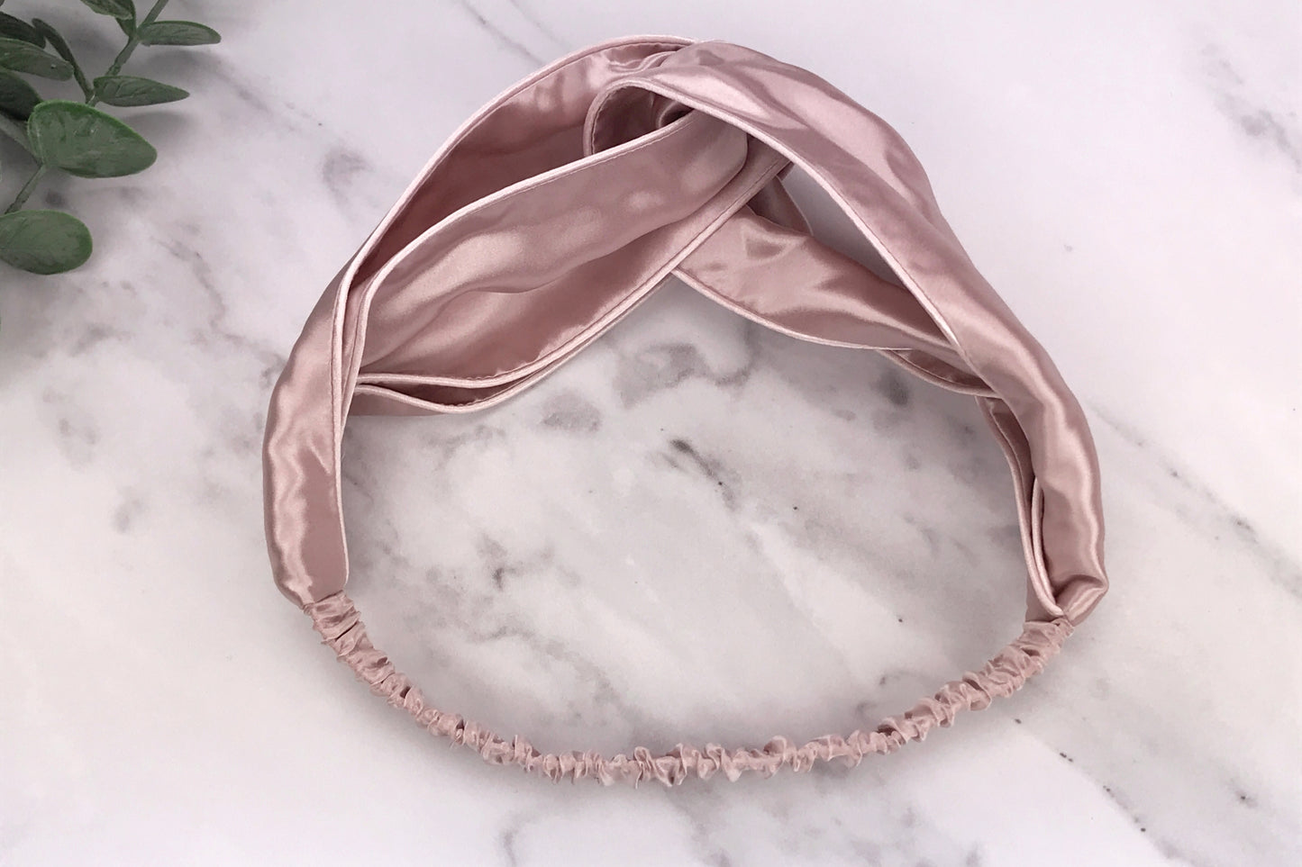 celestial silk twisted vintage pink silk headband for hair on counter with aloe